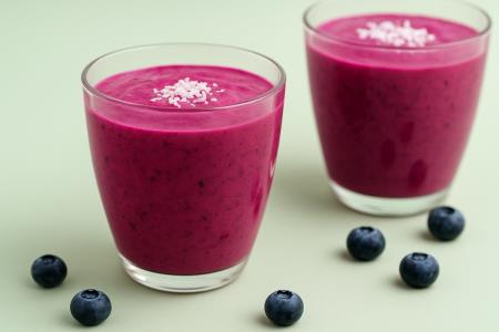 A smoothie recipe called the elixir of youth: berries, kefir, and lemon in a glass of energy